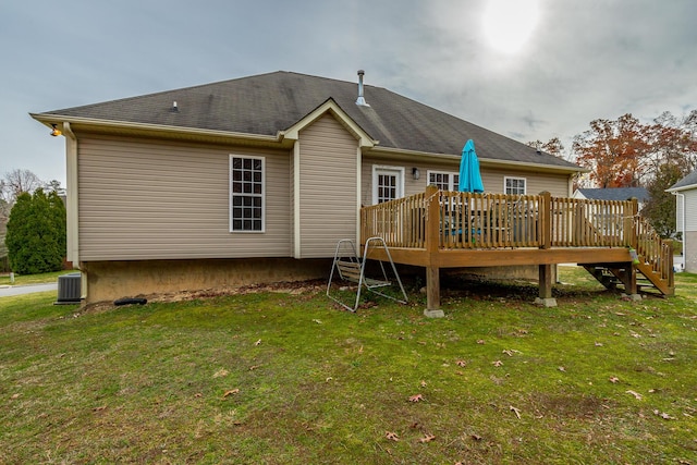 back of house with a deck, a yard, and central air condition unit