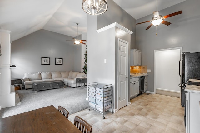 carpeted living room with ceiling fan with notable chandelier, high vaulted ceiling, and wine cooler