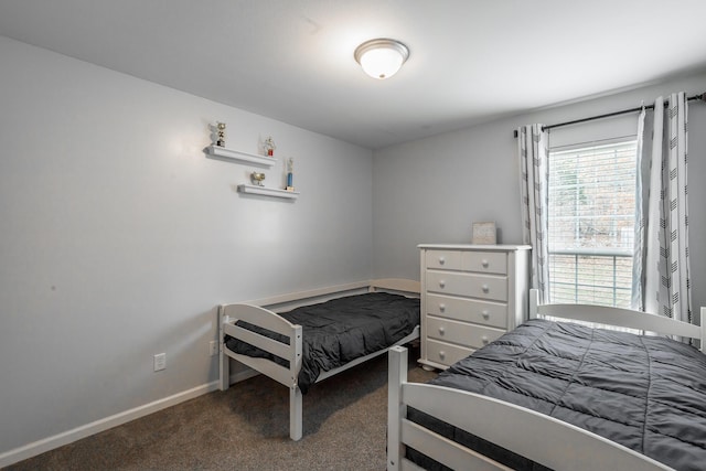 bedroom featuring dark carpet