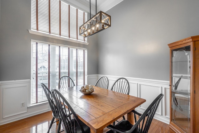 dining area featuring light hardwood / wood-style flooring, plenty of natural light, and ornamental molding