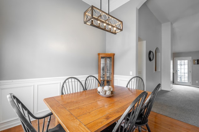 dining room with vaulted ceiling and light wood-type flooring