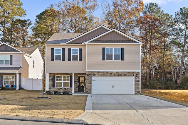 view of front of home with a front yard and a garage