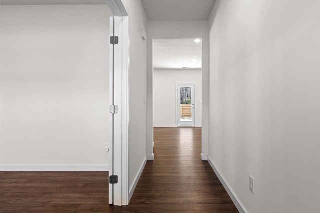 hallway with dark wood-type flooring