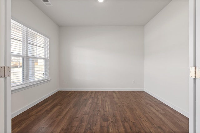 empty room with dark wood-type flooring