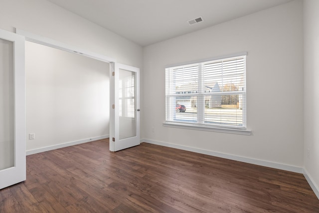 unfurnished room with dark hardwood / wood-style flooring and french doors