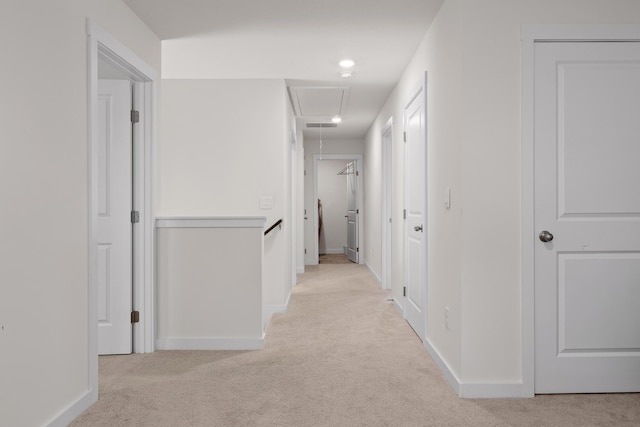 hall with light colored carpet