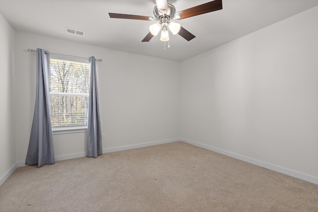 carpeted empty room featuring ceiling fan