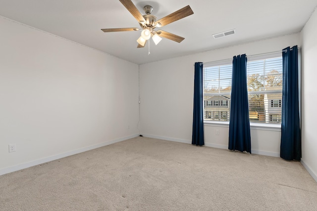 unfurnished room featuring ceiling fan and light carpet