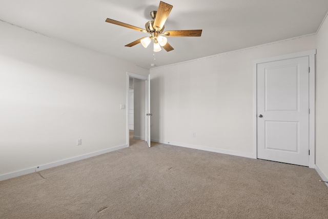 spare room with light carpet and ceiling fan