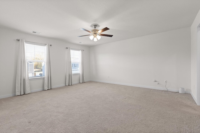 carpeted spare room featuring ceiling fan