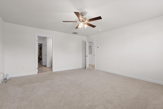 carpeted spare room featuring ceiling fan