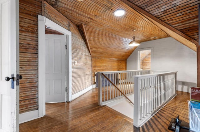 hallway with dark hardwood / wood-style floors, wooden walls, wood ceiling, and lofted ceiling