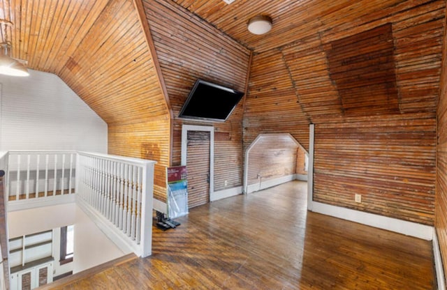 bonus room featuring wood walls, dark wood-type flooring, wood ceiling, and lofted ceiling