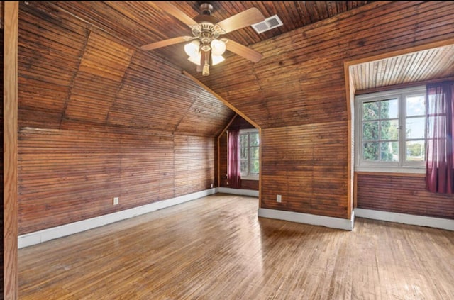 bonus room featuring ceiling fan, wooden walls, wooden ceiling, hardwood / wood-style floors, and lofted ceiling