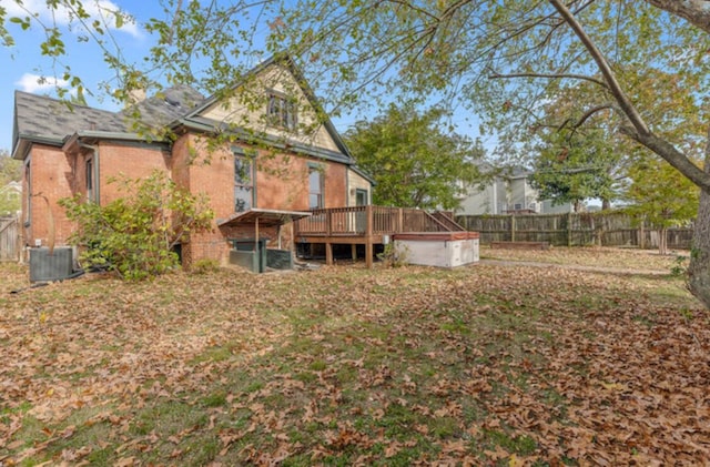 back of property with a wooden deck and central AC unit