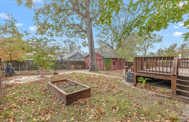 view of yard with a deck and an outdoor structure