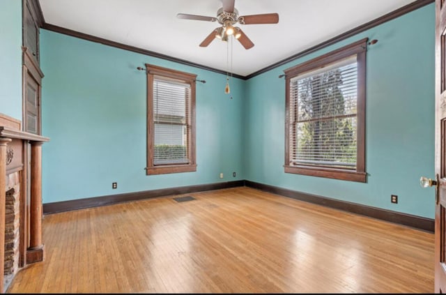 spare room with ceiling fan, ornamental molding, and light hardwood / wood-style flooring