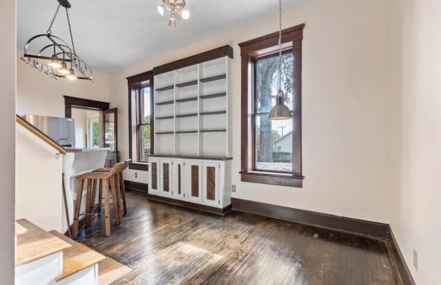 entrance foyer with dark hardwood / wood-style flooring and an inviting chandelier