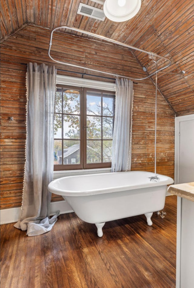 bathroom with a tub to relax in, wooden ceiling, vaulted ceiling, and hardwood / wood-style flooring