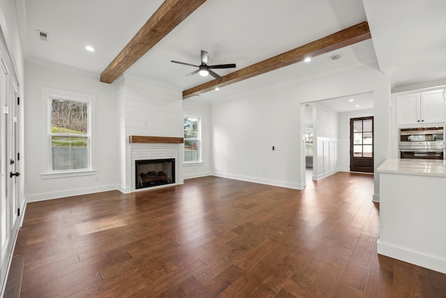 3511 Hawks Creek Dr, Apison, TN 37302 - unfurnished living room with a brick fireplace, visible vents, beamed ceiling, ceiling fan, and dark wood-style flooring