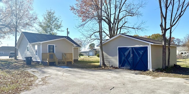 exterior space featuring a garage and an outdoor structure