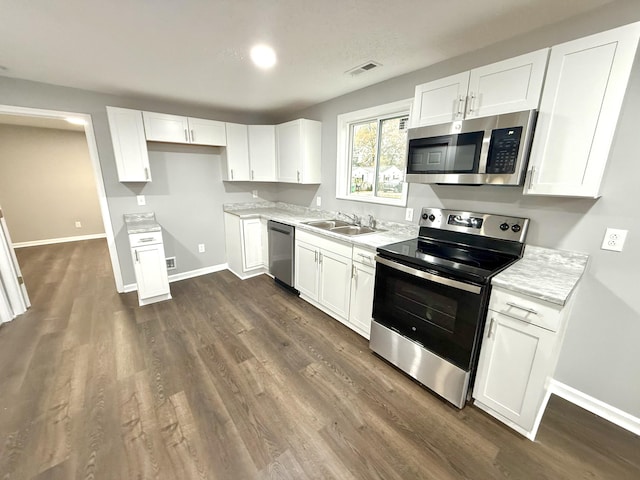 kitchen featuring sink, white cabinets, and appliances with stainless steel finishes