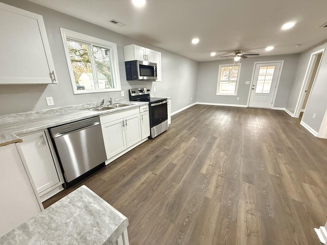 kitchen featuring sink, ceiling fan, dark hardwood / wood-style flooring, white cabinetry, and stainless steel appliances