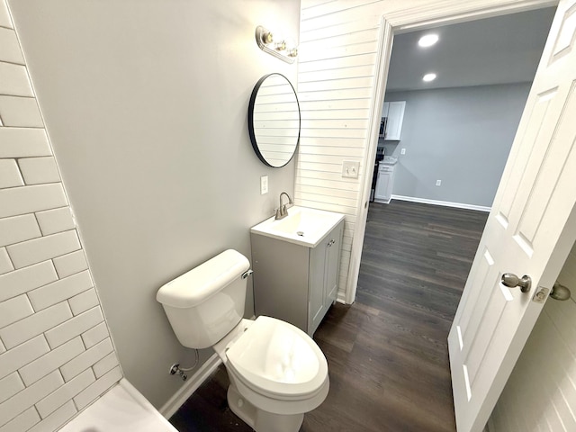 bathroom featuring vanity, hardwood / wood-style flooring, and toilet