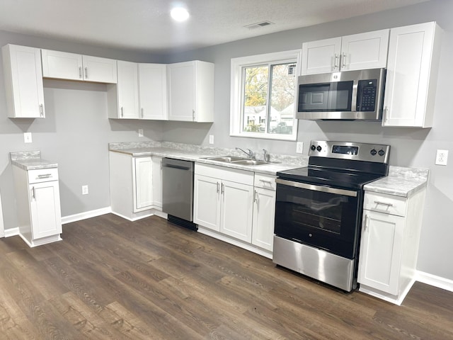 kitchen featuring white cabinetry, dark hardwood / wood-style flooring, stainless steel appliances, and sink