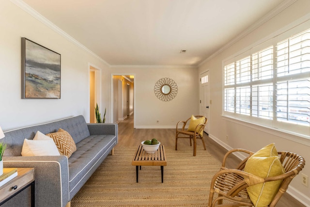 living room with wood-type flooring and ornamental molding