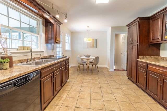 kitchen featuring rail lighting, sink, pendant lighting, light tile patterned floors, and dishwasher