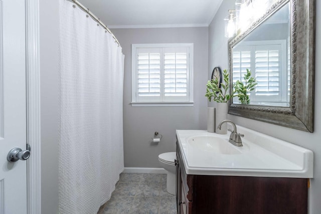 bathroom with tile patterned floors, a wealth of natural light, vanity, and ornamental molding