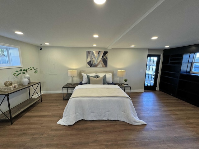 bedroom with access to exterior and dark hardwood / wood-style flooring