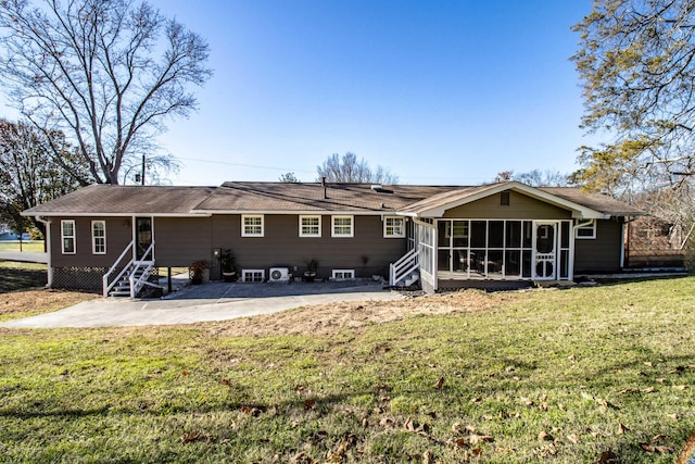 back of house featuring a sunroom, a yard, and a patio