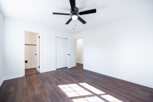 unfurnished bedroom with ceiling fan and dark wood-type flooring