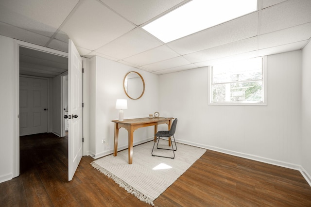 office area featuring a paneled ceiling and dark wood-type flooring