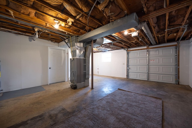 garage with a garage door opener and heating unit