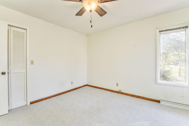 spare room featuring carpet flooring, ceiling fan, and baseboard heating