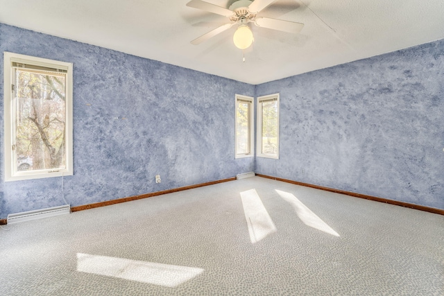 unfurnished room with ceiling fan, carpet, and a textured ceiling