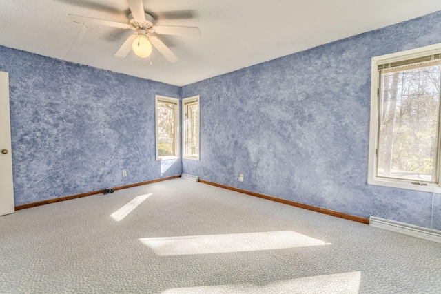 empty room with carpet flooring, a wealth of natural light, and ceiling fan