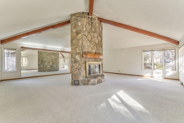 unfurnished living room featuring vaulted ceiling with beams, a stone fireplace, and carpet floors