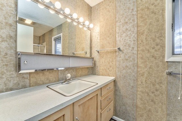 bathroom featuring vanity and a shower with shower door