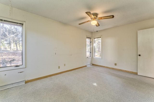 unfurnished room with ceiling fan, carpet floors, a textured ceiling, and a baseboard heating unit