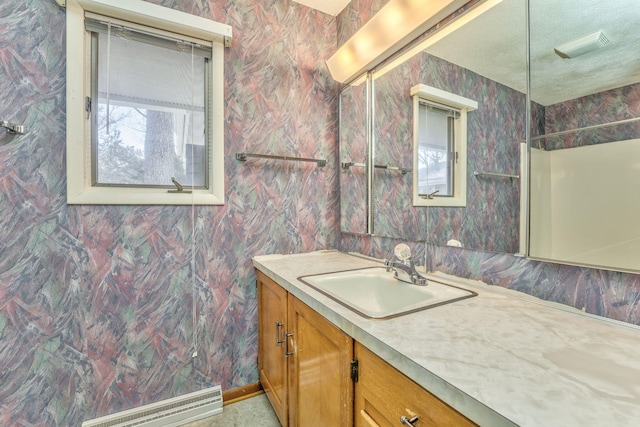 bathroom with a textured ceiling and vanity