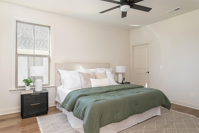 bedroom with ceiling fan and light wood-type flooring