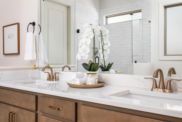 bathroom featuring vanity and an enclosed shower