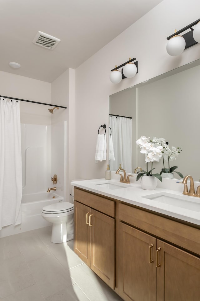 full bathroom with tile patterned floors, vanity, shower / tub combo, and toilet