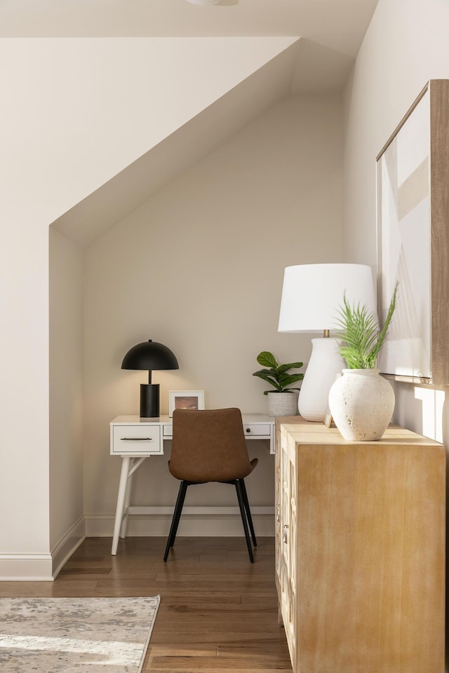 home office with lofted ceiling and hardwood / wood-style flooring