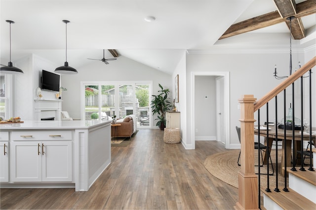 kitchen featuring pendant lighting, dark wood-type flooring, white cabinets, lofted ceiling with beams, and ceiling fan