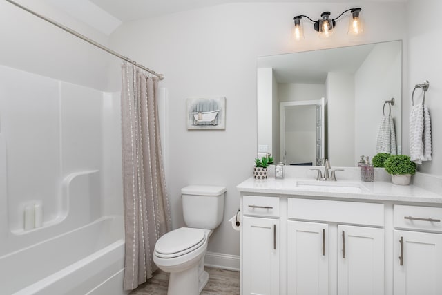 full bathroom featuring shower / bath combination with curtain, vanity, toilet, and vaulted ceiling